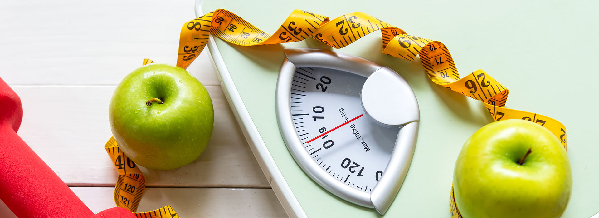 The image shows a scale with apples on it, suggesting a focus on health and nutrition.